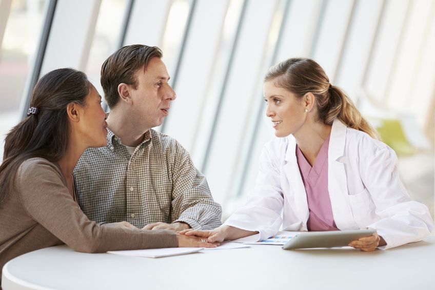 female doctor speaking with patients