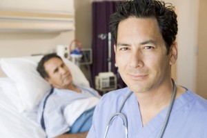 doctor standing in patients room. image is being used to represent a locum tenens hospitalist and the role they plan in helping hospitals serve their patients.